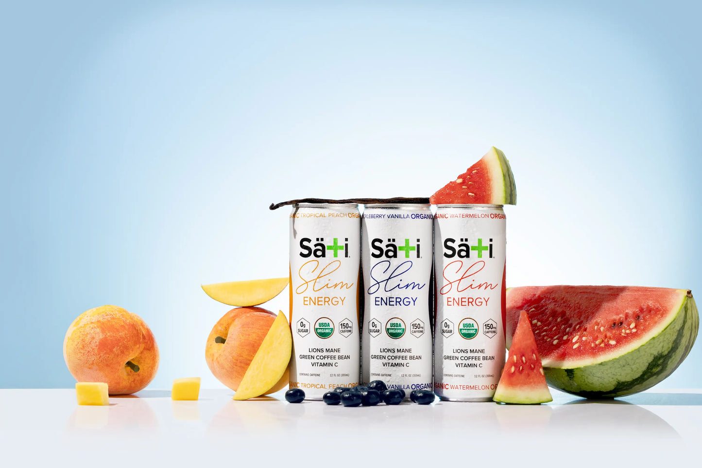Three Sati Slim Energy drink cans with fruits on a light blue background